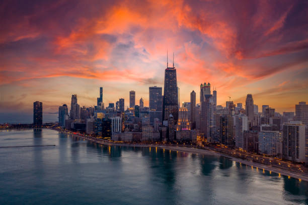 The skyline of downtown Chicago is visible from the north side of the city at sunset.