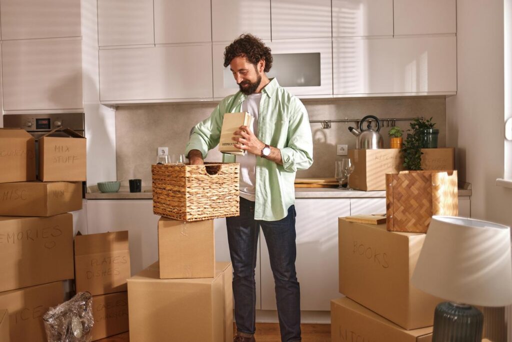 A man packs up his kitchen as he prepares to move out of his apartment.
