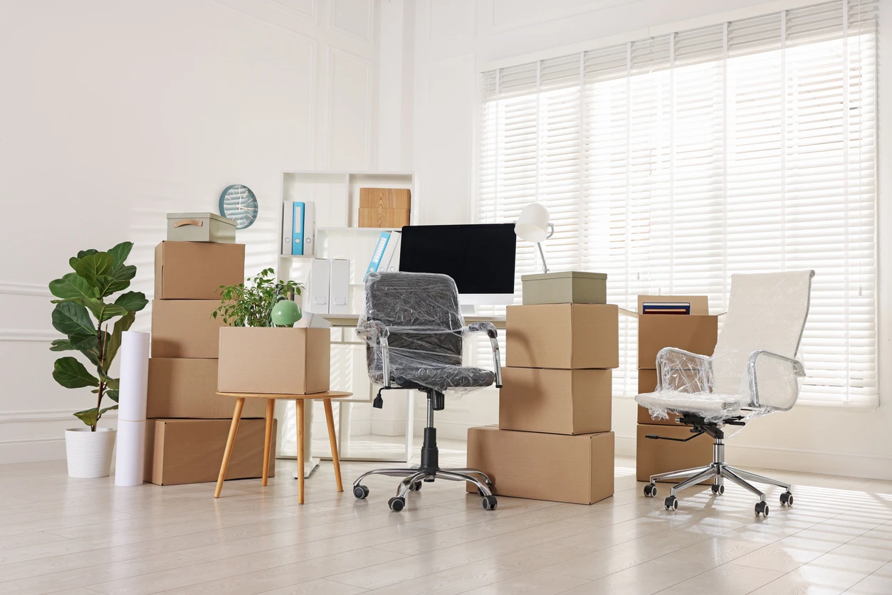 Cardboard boxes, computer and furniture in office