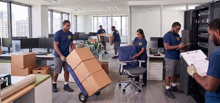 Aaron Bros Moving System crew relocating office furniture and equipment in a modern Chicago high-rise office
